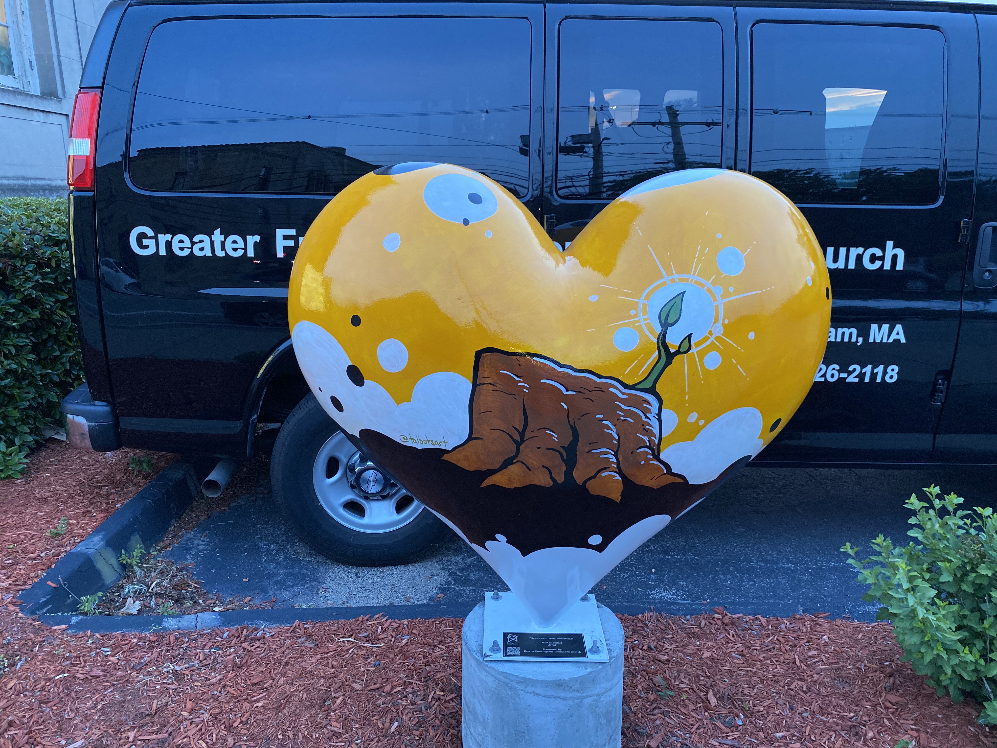 Hearts Around Framingham sculpture in front of the church van